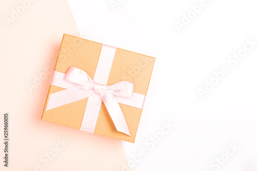 Gift box on pink and white combination background. international women's day concept. Top view, flat lay. Copy space.