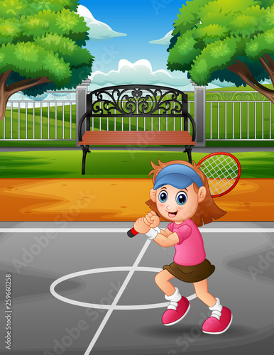 Happy girl playing tennis at the courts