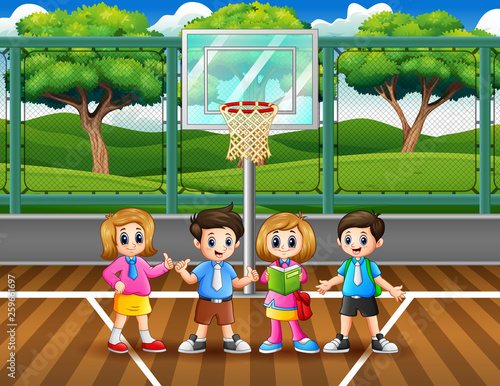 Happy school children in the basketball court