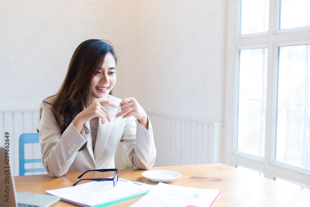 Protrait of Beautiful businesswoman sitting at desk and working with laptop computer. Protrait of Beautiful businesswoman sitting at desk and working with laptop computer.