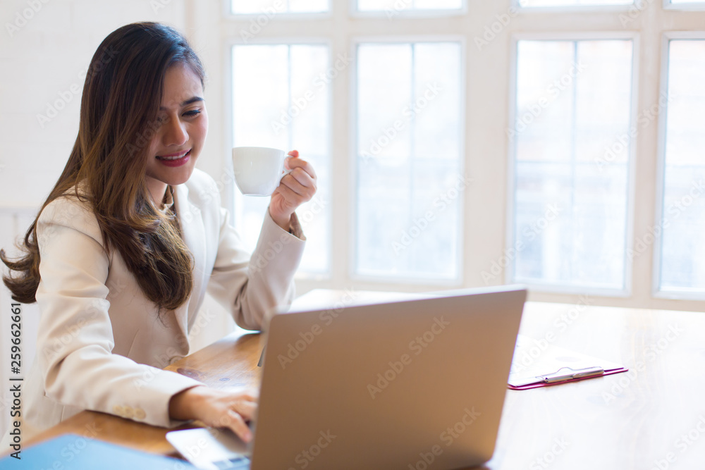 Protrait of Beautiful businesswoman sitting at desk and working with laptop computer. Protrait of Beautiful businesswoman sitting at desk and working with laptop computer.