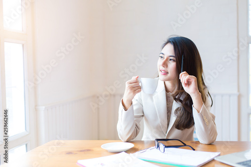 Protrait of Beautiful businesswoman sitting at desk and working with laptop computer.