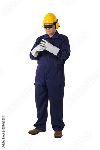 portrait of a worker in Mechanic Jumpsuit is Removing gloves isolated on white background