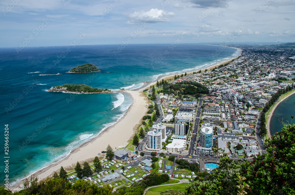 View of the coastline from the top of Mount Manganui with blue sky above, Tauranga, North Island, New Zealand