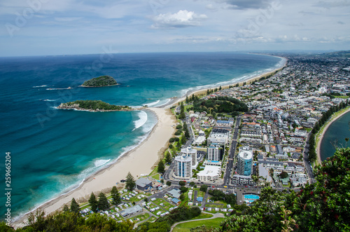 View of the coastline from the top of Mount Manganui with blue sky above, Tauranga, North Island, New Zealand photo