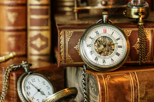 Pocket watch and old books