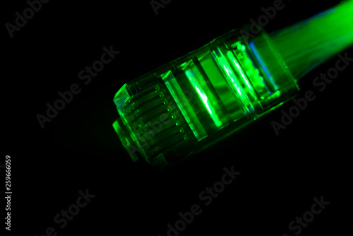 Network connection plug with fiber optics cable isolated on black background