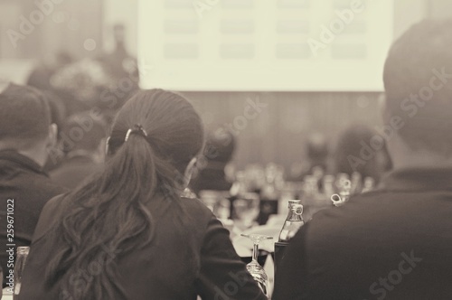 Image close up environmental of White paper with pencil and glass with bottled water setup on the table for the speech of the lecture ,Prepare conference in the hotel. Processed color tone.