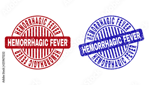 Grunge HEMORRHAGIC FEVER round stamp seals isolated on a white background. Round seals with distress texture in red and blue colors. photo
