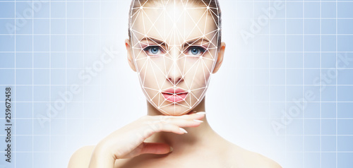 Face of a beautifyl girl with a scnanning grid on her face. Face id, security, facial recognition, authentication technology. photo