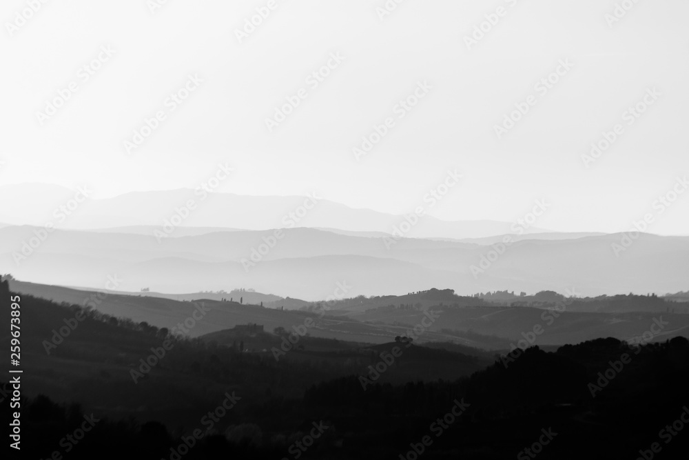 Beautiful view of Tuscany hills at sunset with mist Beautiful view of Tuscany hills at sunset with mist
