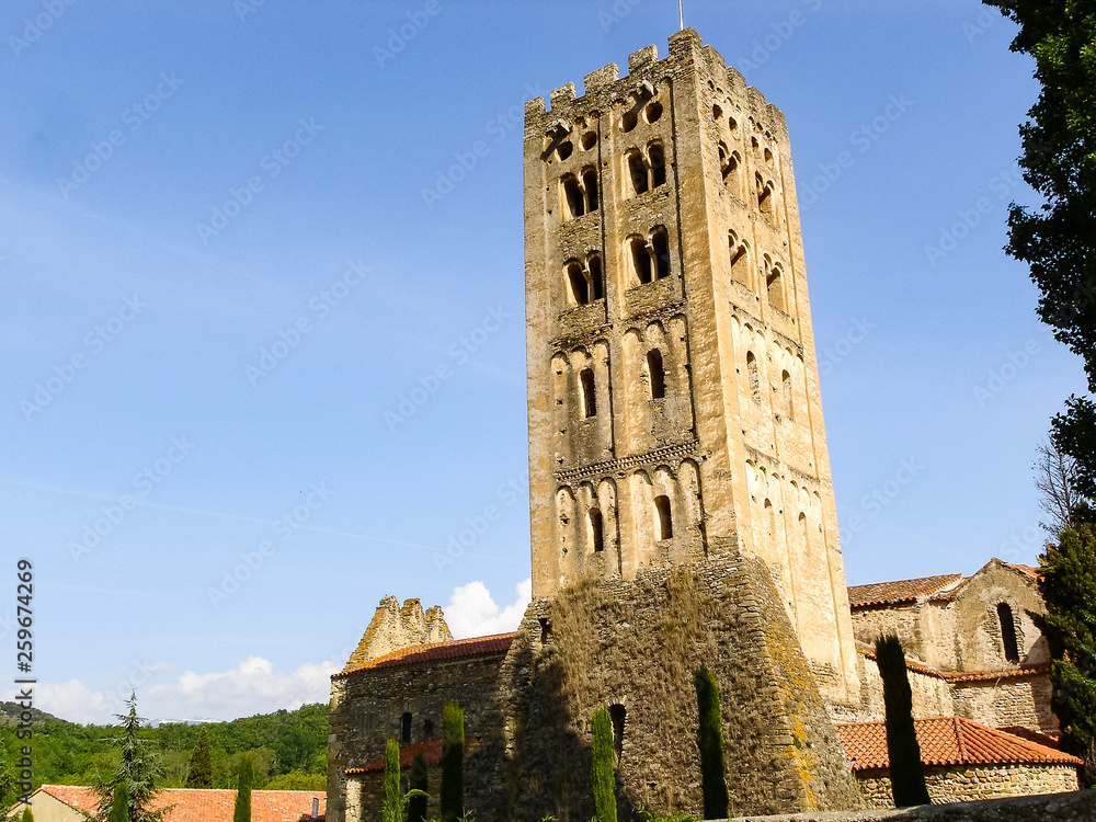 An old tower made of stone in front of the blue sky