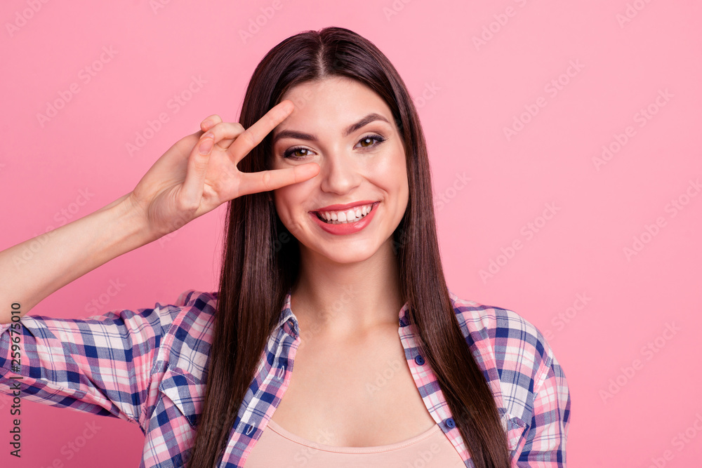 Close up photo amazing beautiful her she lady hold arm hand fingers show v-sign say hi friends relatives positive mood wear casual checkered plaid shirt clothes outfit isolated pink background