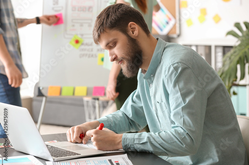 Male IT designer working in...