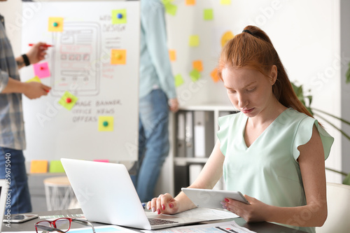 Female IT designer working in office