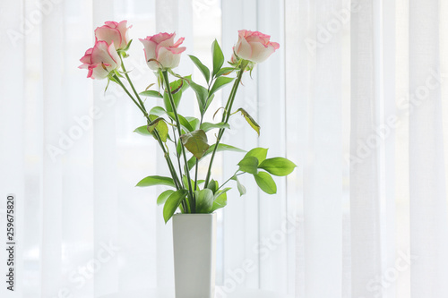 Vase with beautiful flowers in room