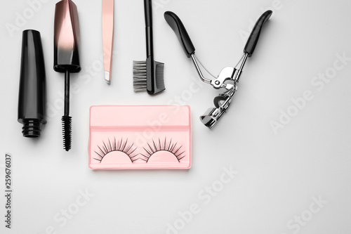 Fototapeta Naklejka Na Ścianę i Meble -  Mascara with false eyelashes and tools on white background
