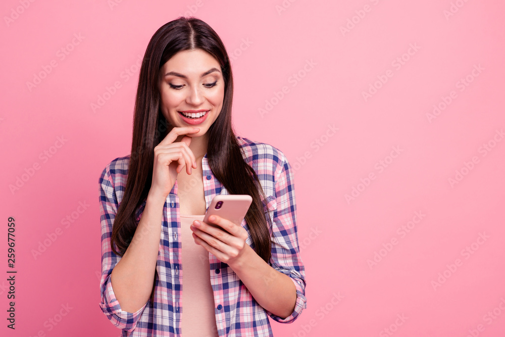 Close-up portrait of her she nice-looking attractive cute charming winsome shine lovely cheerful straight-haired lady holding in hands cell thinking isolated over pink pastel background Close-up portrait of her she nice-looking attractive cute charming winsome shine lovely cheerful straight-haired lady holding in hands cell thinking isolated over pink pastel background