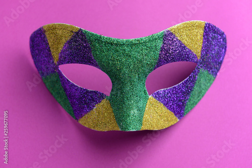 Festive mask on color background