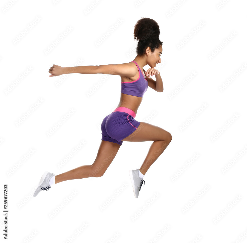 Sporty African-American woman running against white background Sporty African-American woman running against white background