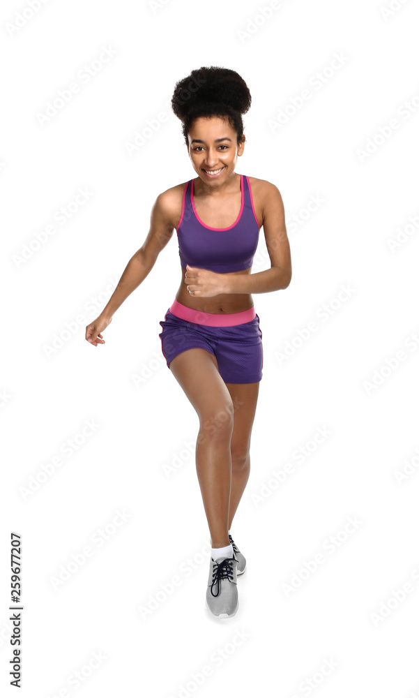 Sporty African-American woman running against white background Sporty African-American woman running against white background