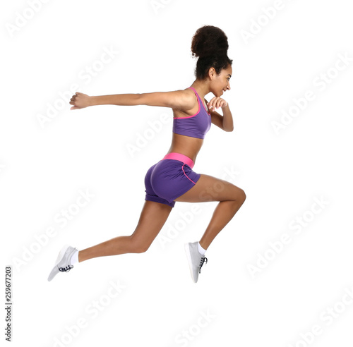 Sporty African-American woman running against white background