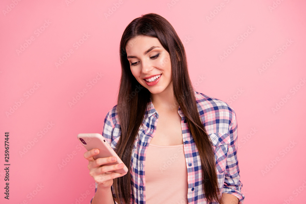Close-up portrait of nice-looking attractive cute charming winsome lovely cheerful straight-haired lady wearing checked shirt browsing wi-fi connection having fun isolated over pink background Close-up portrait of nice-looking attractive cute charming winsome lovely cheerful straight-haired lady wearing checked shirt browsing wi-fi connection having fun isolated over pink background