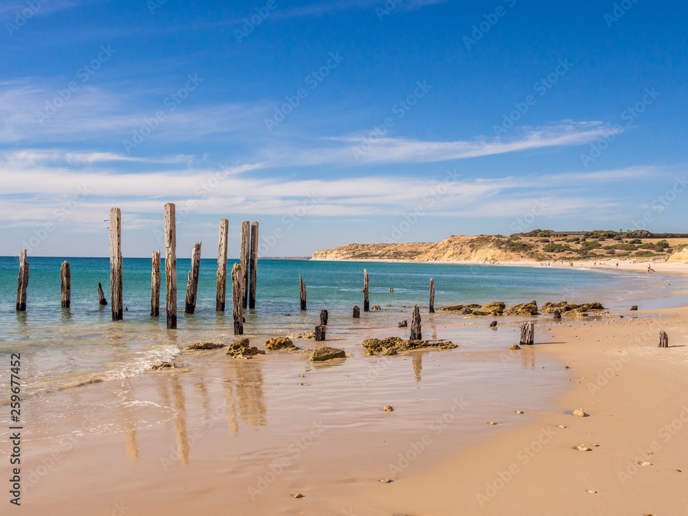 Old wooden pier posts at Port Willunga beach, Adelaid, South Australia Old wooden pier posts at Port Willunga beach, Adelaid, South Australia