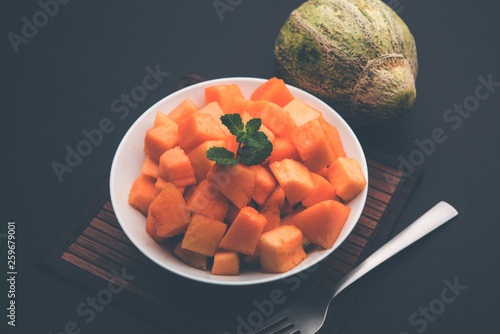 Cantaloupe / muskmelon / kharbuja cut into pieces, served in a bowl. selective focus photo