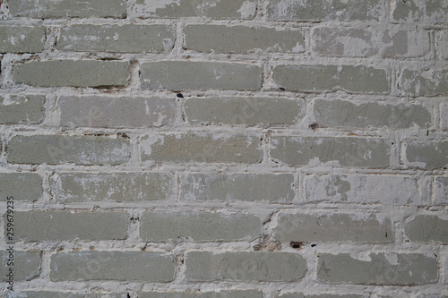 Light white or grey brick wall of antique church. Texture wallpaper background. Dirty old wall. Vintage structure.