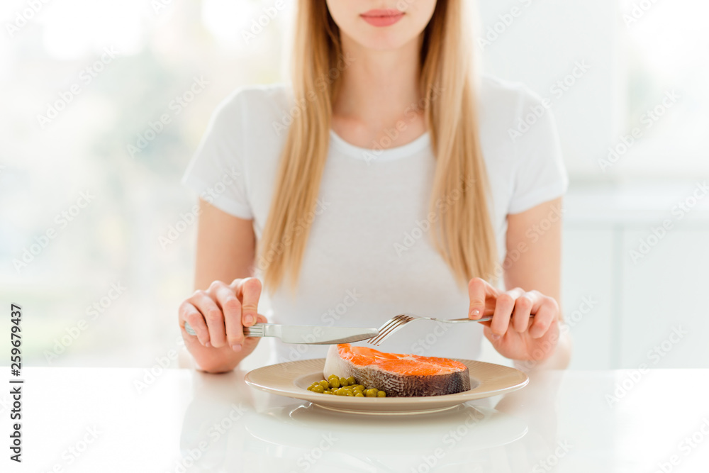 Portrait of charming cute attractive lady have dinner lunch full of protein use fork knife silverware taste hungry want eat dressed in modern stylish clothes sit in fashionable apartment