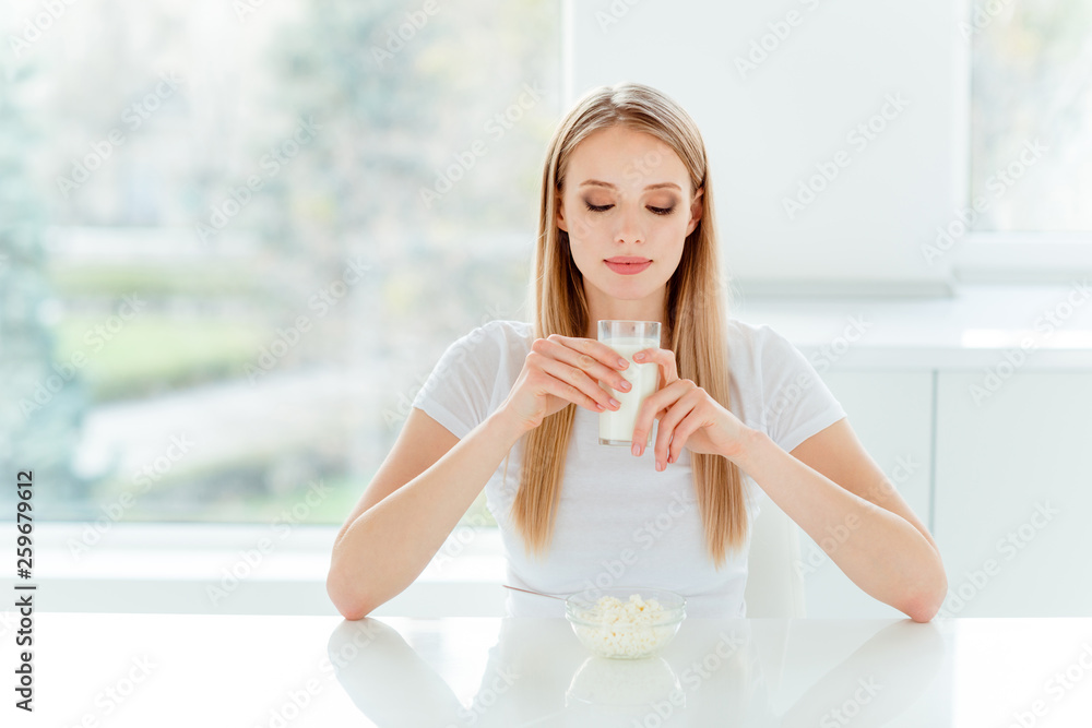 Portrait of her she nice-looking cute charming lovely attractive calm peaceful straight-haired girl wearing white tshirt tasting good useful beverage in light white interior room Portrait of her she nice-looking cute charming lovely attractive calm peaceful straight-haired girl wearing white tshirt tasting good useful beverage in light white interior room