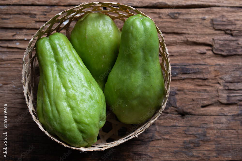 Fresh chayote fruits (Sechium edulis) on wood background Fresh chayote fruits (Sechium edulis) on wood background