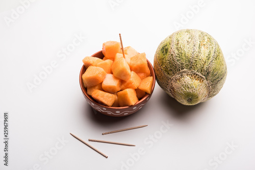 Cantaloupe / muskmelon / kharbuja cut into pieces, served in a bowl. selective focus photo