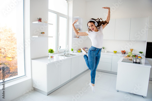 Full length body size view portrait of her she nice attractive crazy childish playful girlish cheerful cheery wavy-haired girl having fun in modern light white interior style room #259680451