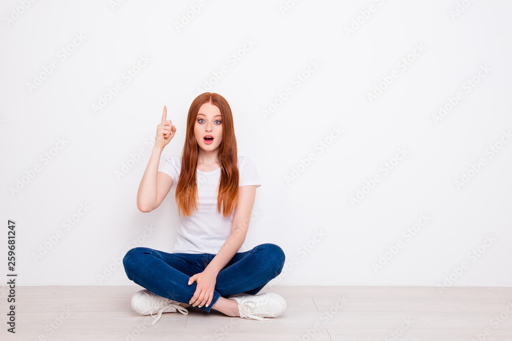 Full length body size photo beautiful she her lady sit floor legs crossed ponder pensive having idea finger raised up delight wear casual t-shirt jeans denim outfit clothes isolated white background