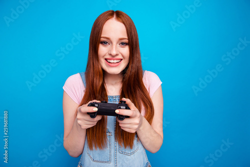 Close up photo beautiful amazing she her lady funny hold hands arms video game controller hard match worry team success want win wear casual jeans denim overalls clothes isolated blue background