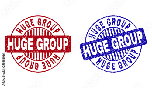 Grunge HUGE GROUP round stamp seals isolated on a white background. Round seals with distress texture in red and blue colors. Vector rubber imprint of HUGE GROUP text inside circle form with stripes.