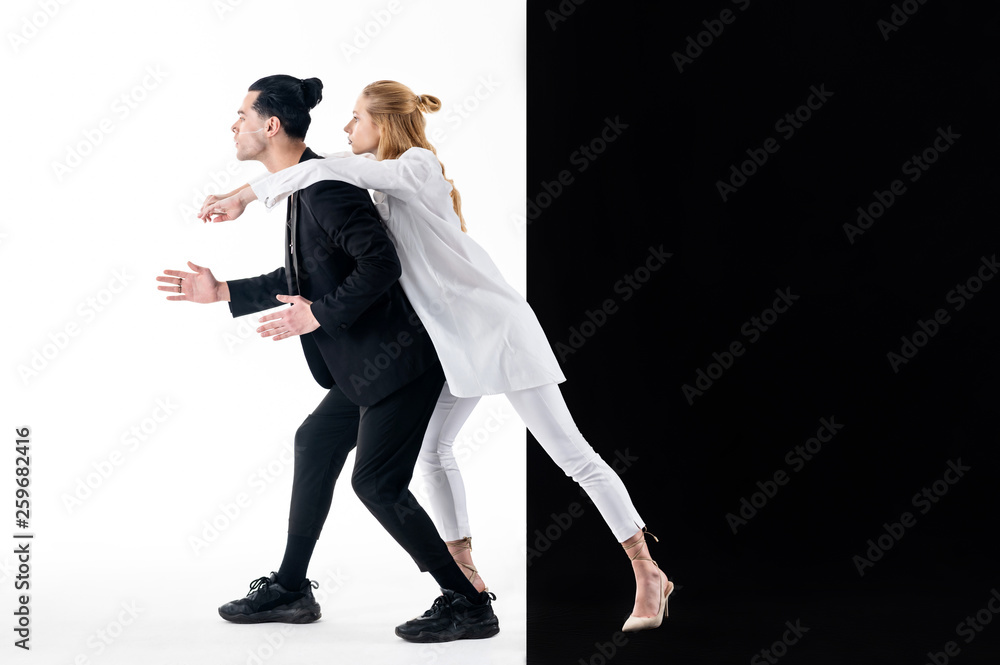 Blonde model wearing high-heeled shoes hugging her colleague Blonde model wearing high-heeled shoes hugging her colleague