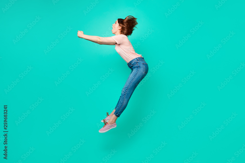 Full length side profile body size photo beautiful amazing her she lady flight umbrella afraid scared height blown away no wear casual jeans denim pastel t-shirt isolated teal turquoise background