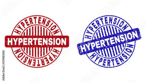 Grunge HYPERTENSION round stamp seals isolated on a white background. Round seals with grunge texture in red and blue colors.