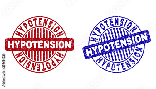 Grunge HYPOTENSION round stamp seals isolated on a white background. Round seals with distress texture in red and blue colors.