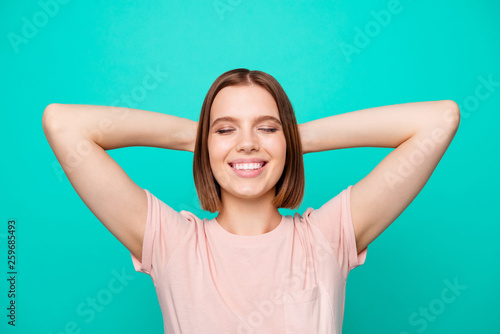 Portrait of cute charming lady youngster close eyes touch head back enjoy have weekdays holidays feel rejoice content isolated dressed pink fashionable shirts on turquoise background © deagreez