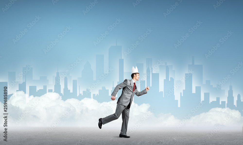 King businessman in elegant suit running and blue cityscape silhouette at background
