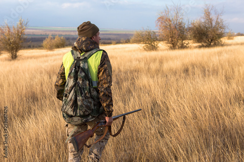 Hunters with a german drathaar and spaniel  pigeon hunting with dogs in reflective vests 