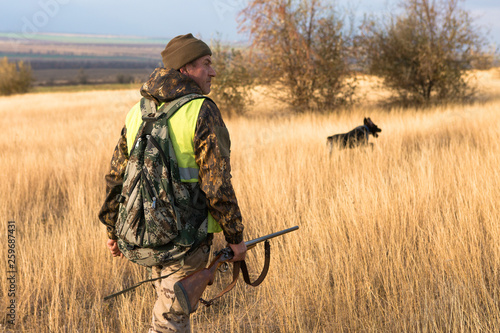 Hunters with a german drathaar and spaniel  pigeon hunting with dogs in reflective vests 