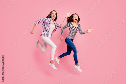 Quick Full length body size photo of funky satisfied enthusiastic teens teenagers have free time scream laugh carefree fool childish isolated wear fashionable clothes on pink background