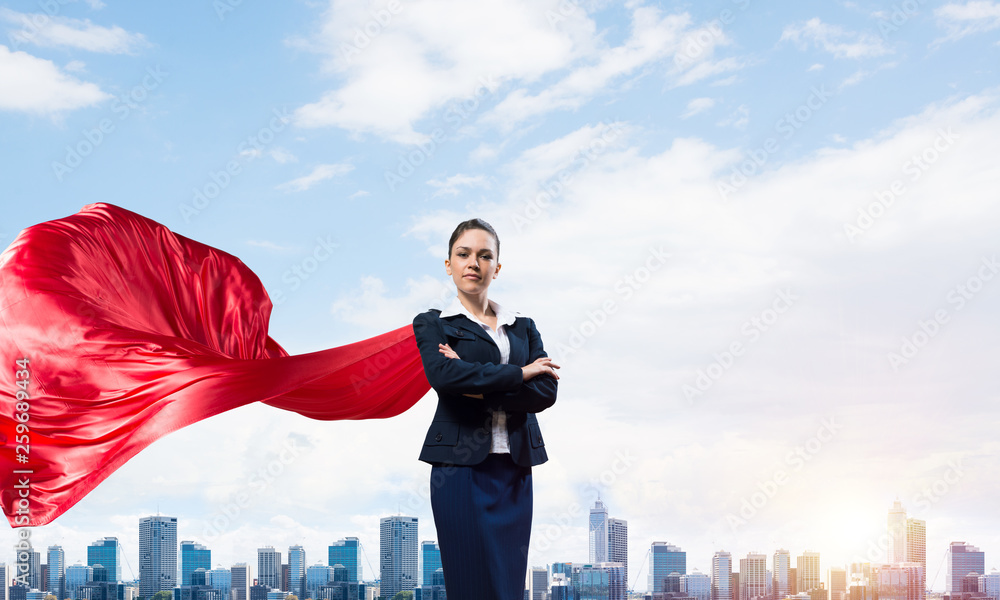 Concept of power and sucess with businesswoman superhero in big city
