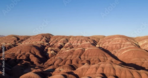 Flying over the red, colorful, rainbow mountains, covered with unique patterns, Iran. Aerial photography.