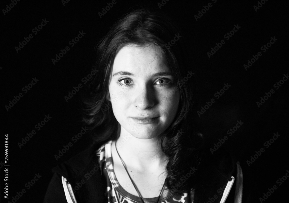 Girl in a black room black and white photo